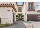 Close-up of a home's front entrance with a walkway leading to an ornate door and a two-car garage at 11453 Glowing Sunset Ln, Las Vegas, NV 89135