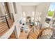 Interior view of a home with curved staircase, wood floors, soaring ceilings, and modern furniture at 11453 Glowing Sunset Ln, Las Vegas, NV 89135
