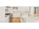 Modern kitchen with white cabinets, stainless steel appliances, a large island, and designer countertop and backsplash at 11453 Glowing Sunset Ln, Las Vegas, NV 89135