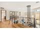 Bright landing features modern railing, doors to balcony, and view of contemporary chandelier at 11453 Glowing Sunset Ln, Las Vegas, NV 89135