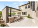 Outdoor kitchen complete with bar seating, grill, tv, and patio at 11453 Glowing Sunset Ln, Las Vegas, NV 89135