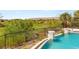Serene poolside view overlooking lush landscaping and community golf course at 11453 Glowing Sunset Ln, Las Vegas, NV 89135