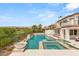 Luxury pool and spa featuring fountains, lush landscaping, and beautiful neighborhood views at 11453 Glowing Sunset Ln, Las Vegas, NV 89135
