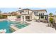 Luxury pool and spa featuring fountains, lush landscaping, and outdoor kitchen at 11453 Glowing Sunset Ln, Las Vegas, NV 89135
