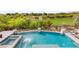 Backyard boasts a stunning in-ground pool and spa with lush landscaping at 11453 Glowing Sunset Ln, Las Vegas, NV 89135
