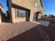 Desert landscaped backyard with patio, fire pit and privacy wall at 117 Logan Pond Way, North Las Vegas, NV 89084