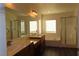 Bright bathroom with double sink vanity, soaking tub, and glass enclosed shower at 117 Logan Pond Way, North Las Vegas, NV 89084