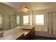 Bright bathroom with double sink vanity, soaking tub, and glass enclosed shower at 117 Logan Pond Way, North Las Vegas, NV 89084