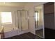 Bathroom featuring a glass shower, soaking tub, and mirrored closet doors at 117 Logan Pond Way, North Las Vegas, NV 89084