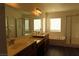 Bathroom with double sinks, a bathtub, and a glass-enclosed shower stall at 117 Logan Pond Way, North Las Vegas, NV 89084