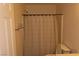 Bathroom featuring a shower with a curtain, toilet, and tiled wall storage at 117 Logan Pond Way, North Las Vegas, NV 89084