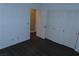 Bedroom with wood flooring, closet, and a neutral color scheme at 117 Logan Pond Way, North Las Vegas, NV 89084