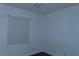 Bedroom with a window, wood flooring, and neutral walls at 117 Logan Pond Way, North Las Vegas, NV 89084