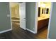 Bedroom showcasing transitions to a bathroom and hallway, along with neutral interior paint at 117 Logan Pond Way, North Las Vegas, NV 89084