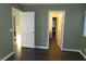 Bedroom highlighting transitions to a bathroom and hallway, along with neutral interior paint at 117 Logan Pond Way, North Las Vegas, NV 89084