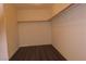 Spacious walk-in closet with wood floors and ample shelving and hanging space at 117 Logan Pond Way, North Las Vegas, NV 89084