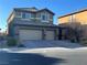 Attractive two-story house boasts a two-car garage and manicured landscaping at 117 Logan Pond Way, North Las Vegas, NV 89084