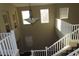 Two-story foyer boasting a decorative chandelier, white railings, and plenty of natural light at 117 Logan Pond Way, North Las Vegas, NV 89084
