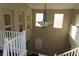 View of a two-story foyer featuring a decorative chandelier and white railing at 117 Logan Pond Way, North Las Vegas, NV 89084