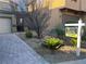 Landscaped front yard with desert plants, a paved driveway and 'For Sale' sign at 117 Logan Pond Way, North Las Vegas, NV 89084