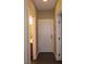 Hallway area with a door to the washroom and access to the garage at 117 Logan Pond Way, North Las Vegas, NV 89084