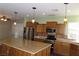Large kitchen island and stainless steel appliances offer room to entertain in this bright space at 117 Logan Pond Way, North Las Vegas, NV 89084