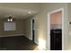 Living room with neutral paint, fan, and a view of the laundry room at 117 Logan Pond Way, North Las Vegas, NV 89084