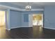 Living room showcasing a light-blue paint, dark laminate floor, and an open layout at 117 Logan Pond Way, North Las Vegas, NV 89084