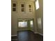Open-concept living room with tall ceilings, lots of light, and hardwood flooring at 117 Logan Pond Way, North Las Vegas, NV 89084
