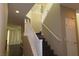 Carpeted staircase with white banister, neutral walls, and natural light at 117 Logan Pond Way, North Las Vegas, NV 89084