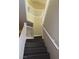 Carpeted staircase with white banister and neutral walls at 117 Logan Pond Way, North Las Vegas, NV 89084