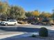 Street view of the landscaped home showcasing its mature trees and shrubbery at 117 Logan Pond Way, North Las Vegas, NV 89084