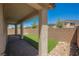 Relaxing back patio with stone pavers, artificial grass, rock landscaping, and private fencing at 12426 Mosticone Way, Las Vegas, NV 89141