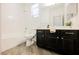 Bathroom with a bathtub and shower combo, dark wood vanity with plenty of storage, and tile floors at 12426 Mosticone Way, Las Vegas, NV 89141