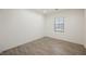 Bedroom with wood-look tile flooring and bright natural light at 12426 Mosticone Way, Las Vegas, NV 89141
