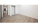 Bright bedroom with wood-look tile flooring, neutral colors, and a closet with sliding doors at 12426 Mosticone Way, Las Vegas, NV 89141