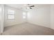 Bright bedroom with carpet flooring, a ceiling fan, and plenty of natural light from two windows at 12426 Mosticone Way, Las Vegas, NV 89141