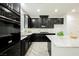 Stylish kitchen with black cabinetry, stainless steel appliances, and granite countertops at 12426 Mosticone Way, Las Vegas, NV 89141