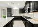 Modern kitchen featuring black cabinets, granite countertops, and a gas range at 12426 Mosticone Way, Las Vegas, NV 89141