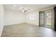 Spacious living room with hardwood floors, ceiling fan, and slider to the backyard at 12426 Mosticone Way, Las Vegas, NV 89141