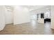 Open-concept living room showcasing stylish floors and access to the kitchen at 12426 Mosticone Way, Las Vegas, NV 89141