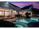 Resort-style backyard featuring a pool, grotto, outdoor seating, and meticulous landscaping, perfect for relaxing at 1610 Brock Ct, Las Vegas, NV 89117