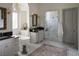 Beautiful bathroom with double vanity, soaking tub, marble-lined shower, and elegant fixtures at 1610 Brock Ct, Las Vegas, NV 89117