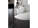 Close-up of a freestanding bathtub with chrome fixtures and a view of the window at 1610 Brock Ct, Las Vegas, NV 89117