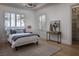 Bedroom showcasing a bed, two windows, and walk-in closet at 1610 Brock Ct, Las Vegas, NV 89117