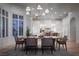 Open-concept dining room featuring a large wooden table and modern chandelier at 1610 Brock Ct, Las Vegas, NV 89117