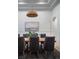 Chic dining room with stylish chairs, wooden table, and pendant lighting at 1610 Brock Ct, Las Vegas, NV 89117