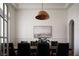 Formal dining room with tray ceilings, wainscoting, stylish pendant lighting and seating for eight at 1610 Brock Ct, Las Vegas, NV 89117