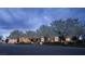 Stunning twilight view of estate with lush landscaping and flowering trees at 1610 Brock Ct, Las Vegas, NV 89117