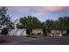 Charming home exterior showcasing lush landscaping, a circular driveway, and elegant architectural details at 1610 Brock Ct, Las Vegas, NV 89117